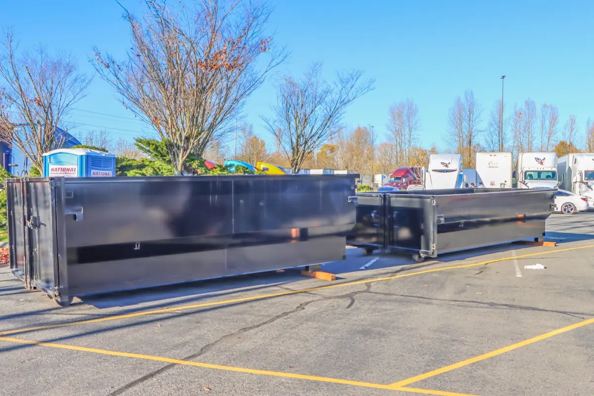 Professional dumpster rental service with roll-off container on residential driveway in Lower Heidelberg